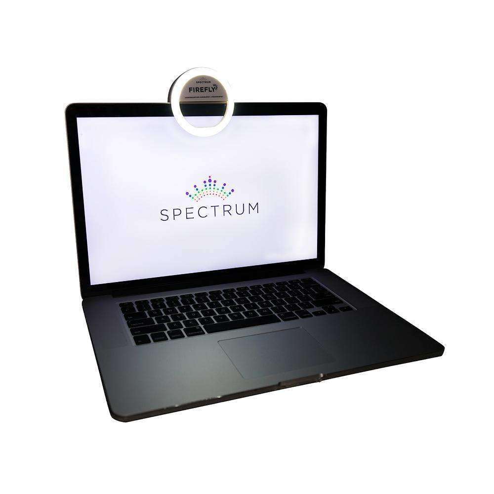 selfie ring light clipped onto macbook