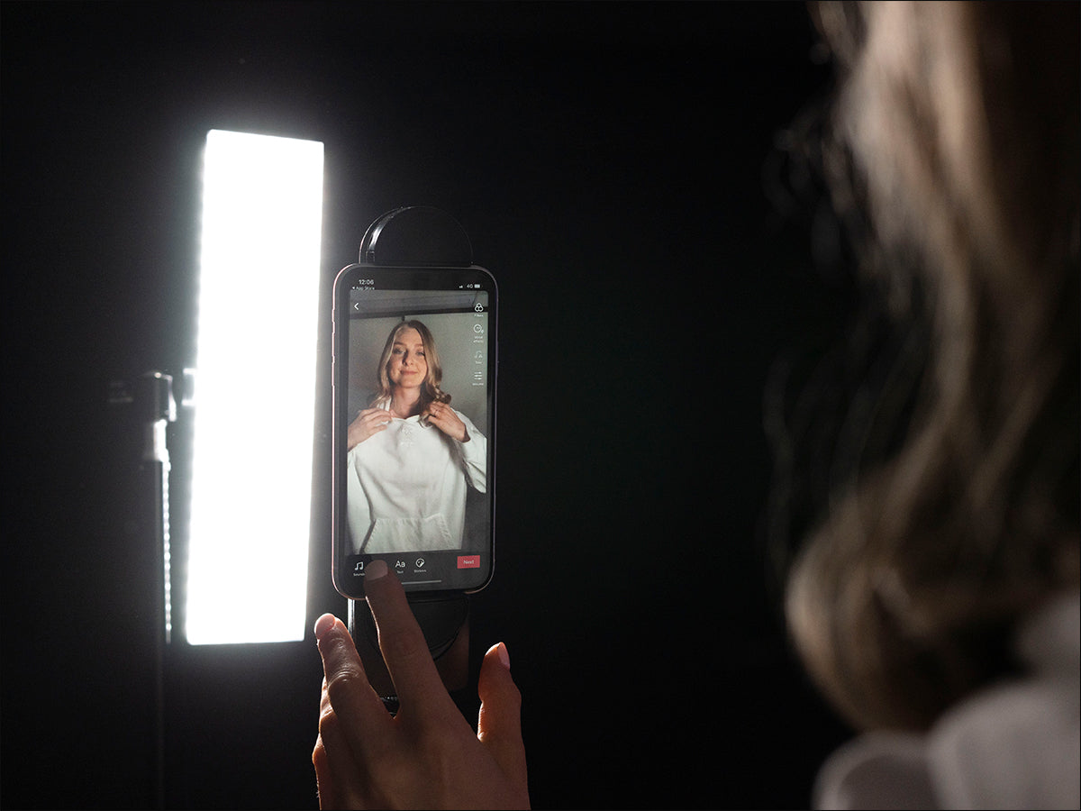 girl making a tik tok video with led video light